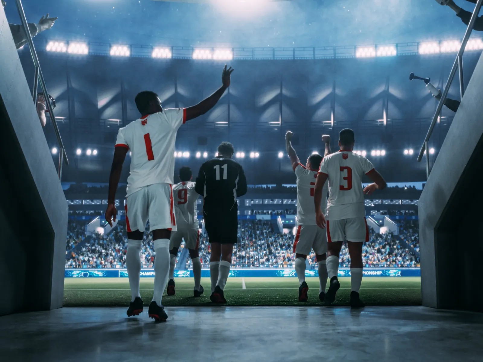Un equipo deportivo saliendo al terreno de juego de un estadio iluminado con focos