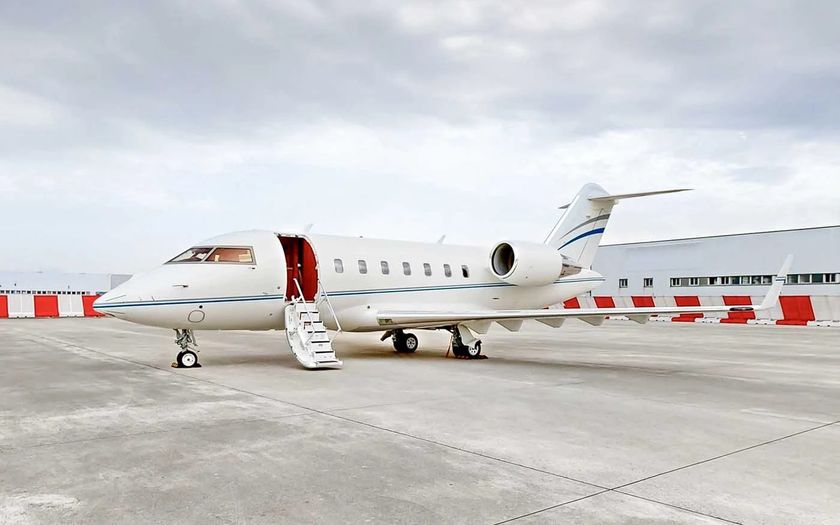 Bombardier Challenger 650 private jet parked on the tarmac with its airstair extended