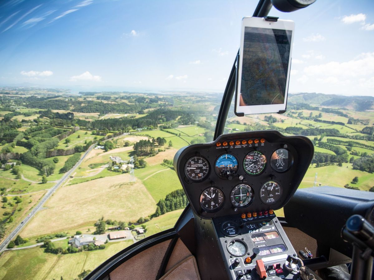 The view over green countryside from a helicopter cockpit