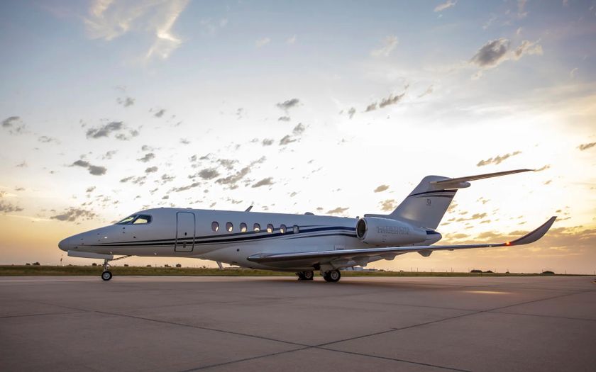 Cessna Citation Longitude private jet parked on the tarmac at sunset