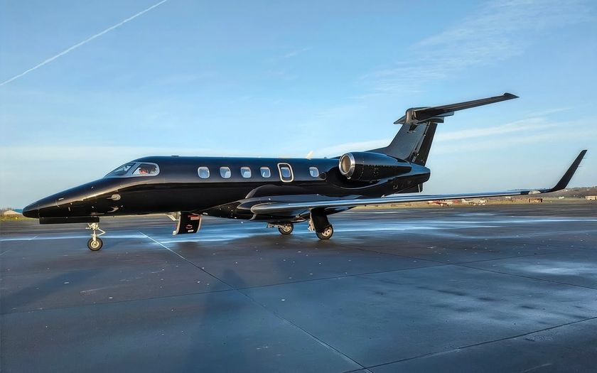 Embraer Phenom 300E private jet parked on the apron