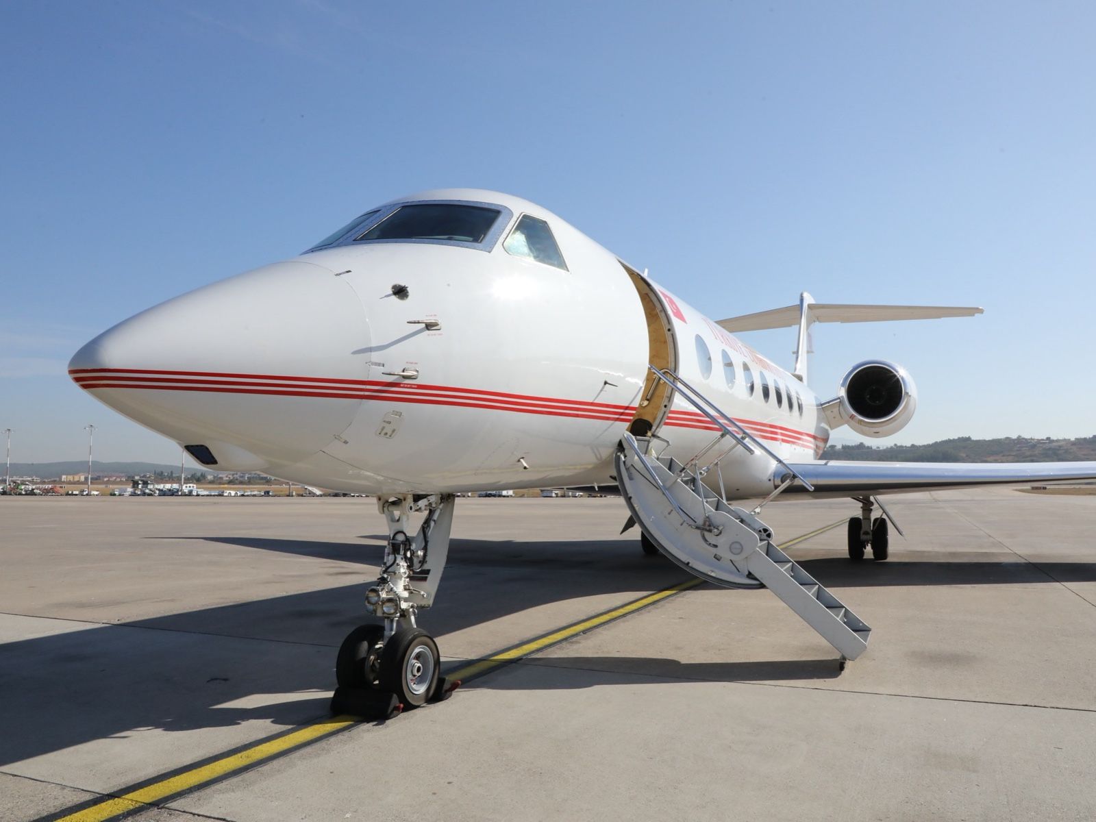 A government state jet on the tarmac with its airstairs down