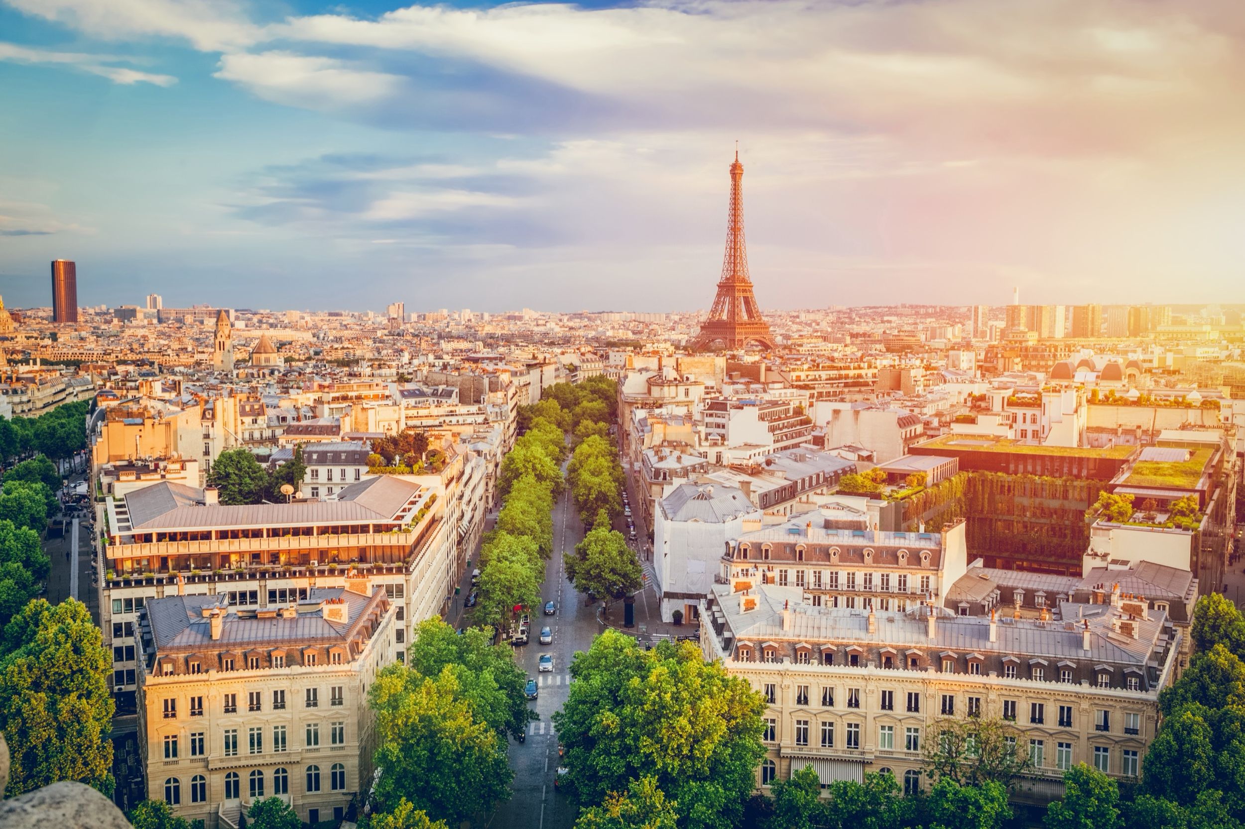Aerial view of Paris at sunset with the Eiffel Tower and Haussmann rooftops